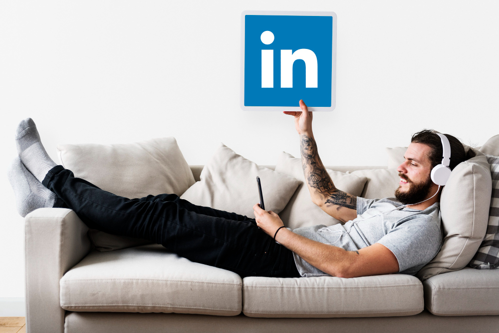 a man holding linkedin icon